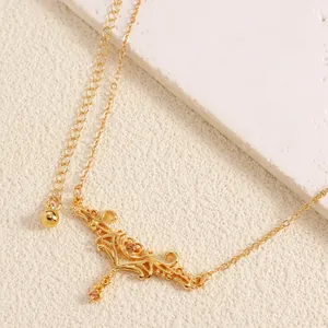 Detailed close-up of vintage gold-toned heart thorn waist chain with dangling rhinestone