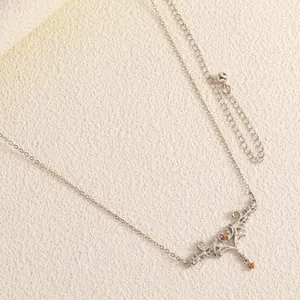 Detailed macro view of silver vintage carved thorn body chain with amber gemstone accent