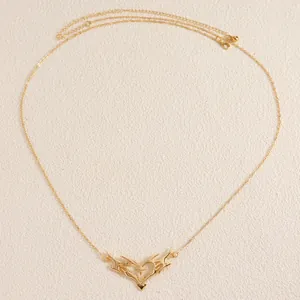 Detailed view of a gold vintage body chain featuring a thorn heart pendant with star motif.