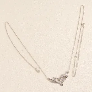Detailed close-up of a silver thorn heart body chain with a retro punk aesthetic design