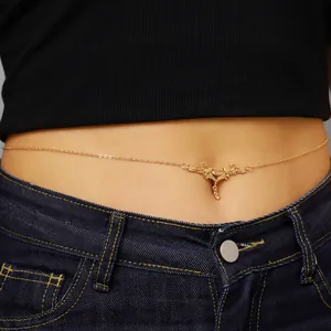 Exquisite close-up of golden vintage carved thorn heart waist chain on a female model