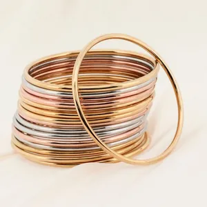 Detail view of 18k gold plated stainless steel stacking bangles with 3mm round wire.
