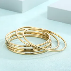 Detailed view of 18k gold plated stainless steel 3mm stacked plain circle bangles.