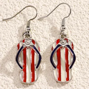 Detailed view of patriotic flip-flop drop earrings with red and white enamel stripes