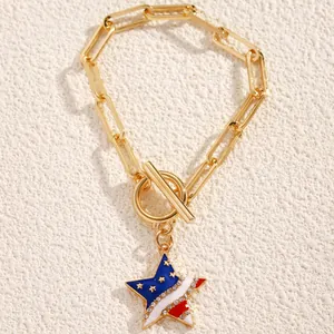 Detail of star pendant with US flag enamel and crystals on golden chunky chain bracelet
