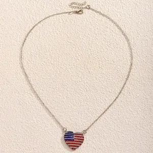 Detail of heart pendant with red white and blue rhinestones on silver chain