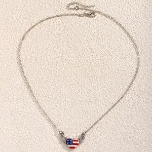 Detail of silver heart necklace with American flag enamel and winged rhinestone pendant