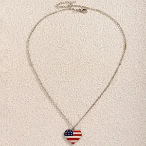 Close-up of heart pendant with US flag enamel pattern and silver link chain with clasp