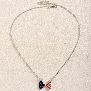 Detail view of silver necklace with American flag bow pendant and adjustable lobster clasp