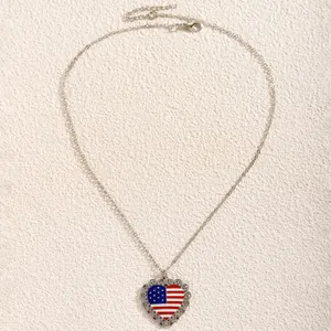 Detail of silver heart pendant with US flag pattern and intricate vintage hollow edges