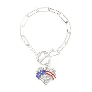 Close-up of heart charm with US flag stars and stripes on silver paperclip bracelet