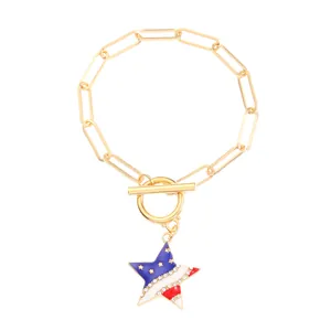 Detail of gold paperclip bracelet with US flag star pendant and sparkling rhinestones