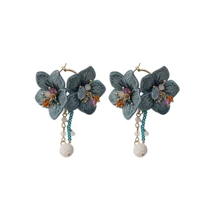 Elegant bohemian long drop earrings featuring blue knitted flowers and white textured pearls