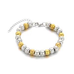 Minimalist two-tone silver and gold beaded bracelet with an adjustable extension chain.