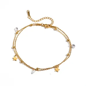 Detail view of a gold stainless steel double-layer anklet with star and crystal charms.