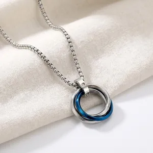 Close-up of stainless steel double ring necklace pendant with blue and silver finish