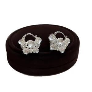 Elegant silver-toned flower basket hoop earrings with delicate pearls and sparkling crystals