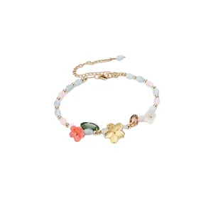 Sweet summer style beaded bracelet with crystal stones and colorful resin flowers.