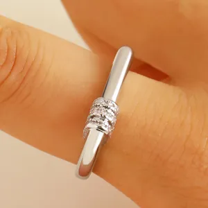 Silver-colored twist ring with three rows of pavé zircons in a minimalist open design