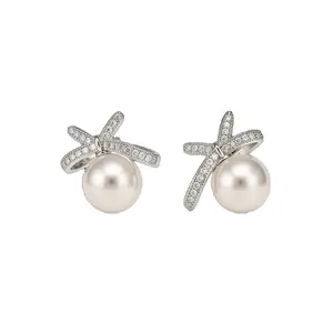 Elegant pearl stud earrings with sparkling pavé bow-knot design on white background