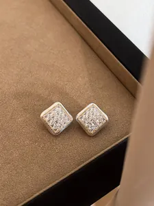 Detailed close-up of elegant square pave stud earrings with sparkling clear crystals