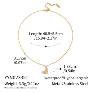 Close-up of heart pendant necklace in gold stainless steel with sparkling crystals