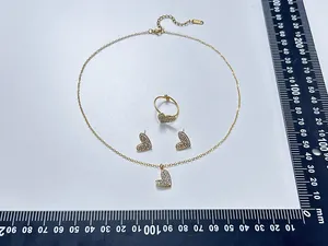 Detail of gold heart jewelry set with sparkling rhinestones and measurement ruler