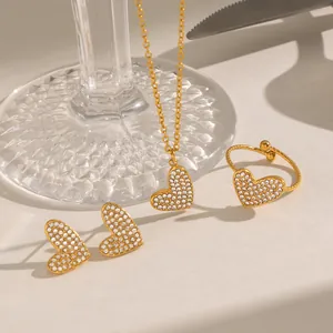 Macro view of gold heart-shaped jewelry set featuring pavé cubic zirconia settings