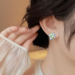 Close-up of colorful dopamine-style acrylic cluster stud earrings with rhinestones