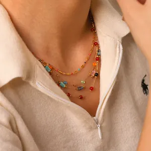 Bohemian multilayer gold necklace with colorful natural stones and beads on a female model