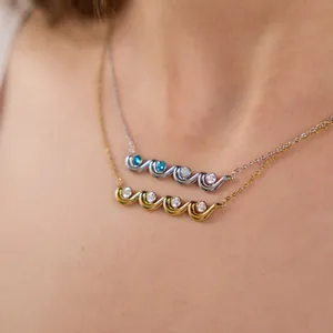 Detail shot of a wave-shaped titanium steel necklace set with sparkling zirconia stones
