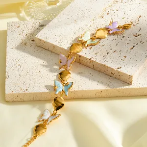 Detailed shot of gold stainless steel bracelet with colorful enamel butterfly charms