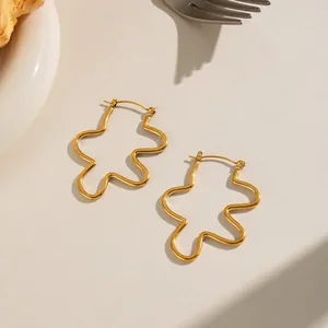 Close-up detail of gold-plated wavy stainless steel earrings with elegant texture