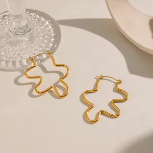 Detail shot of 18K gold plated stainless steel earrings with unique wavy line design.