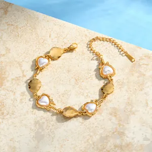 Exquisite close-up of a gold stainless steel bracelet with heart pearls and geometric plates