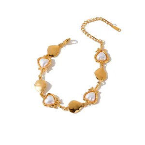 Close-up of gold-plated stainless steel bracelet with heart pearls and hammered links.