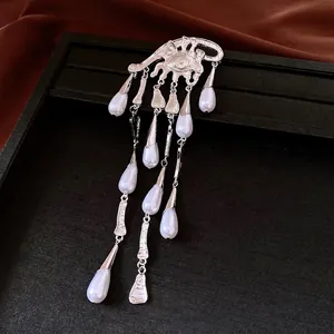 Luxurious silver eye brooch featuring exquisite pearl waterdrop tassels for elegant fashion