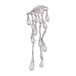 Elegant silver-toned eye brooch with dangling pearl water drop tassels on white background