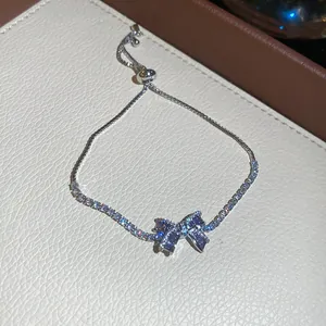 Elegante pulsera bolo plateada con un brillante amuleto de lazo de circonita morada