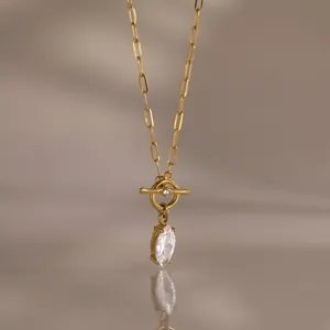 Close-up of 18k gold plated paperclip chain necklace featuring a marquise cut zircon pendant