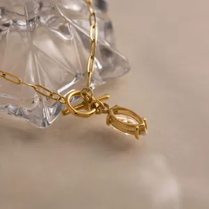 Close-up detail of 18k gold-plated stainless steel necklace with zircon pendant