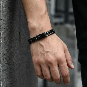 Detail view of men's matte black titanium steel cuban link bracelet on wrist
