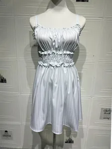 Detail view of the light blue striped floral dress featuring ruffled edges and elastic waist
