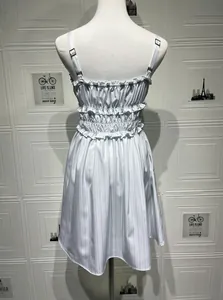 Detail of smocked back dress with ruffled edges and adjustable silver strap buckles