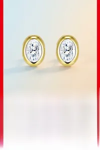 Macro detail of oval moissanite stud earring in gold-plated bezel s925 silver setting