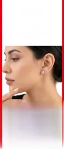 Close-up of elegant oval-cut moissanite stud earring with gold-plated setting on ear