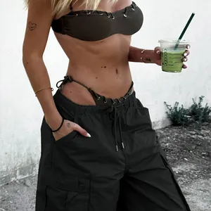 Detail of olive green cargo pants with drawstring waist and large side pocket details