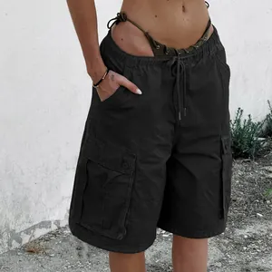 Close-up of cargo shorts featuring elastic drawstring waist and large flap button pockets