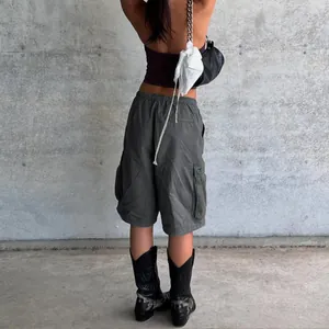 Detail of cargo shorts showing elastic drawstring waist and large side pockets on the back