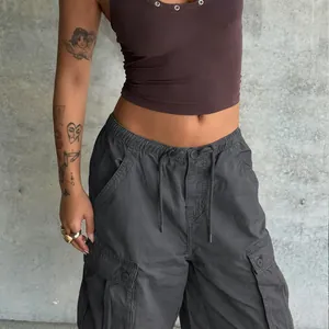 Detail of dark gray cargo shorts featuring an elastic waistband with drawstrings and pockets
